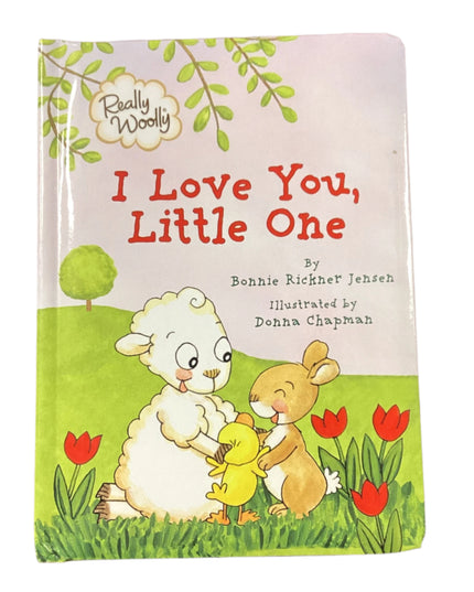 Children's book titled 'I Love You, Little One' on a wooden surface