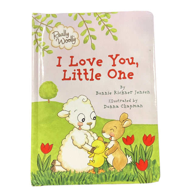 Children's book titled 'I Love You, Little One' on a wooden surface