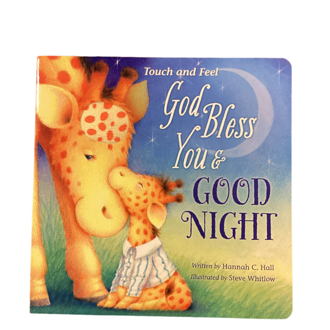 Children's book titled 'God Bless You & Good Night' with a giraffe illustration on a wooden surface.