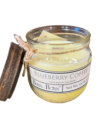 Jar of 'Blueberry Coffee' candle with a label on a wooden surface