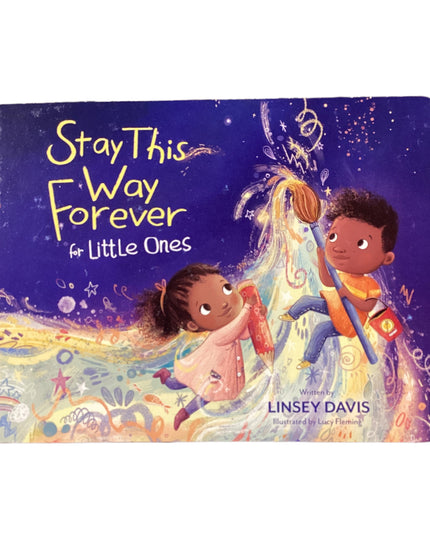 Children's book titled 'Stay This Way Forever for Little Ones' on a wooden surface